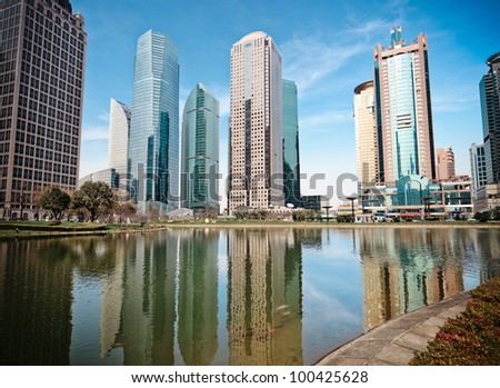 modern buildings and lake water in shanghai greenbelt park