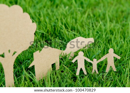 Paper cut of family with house , tree and car on fresh spring green grass