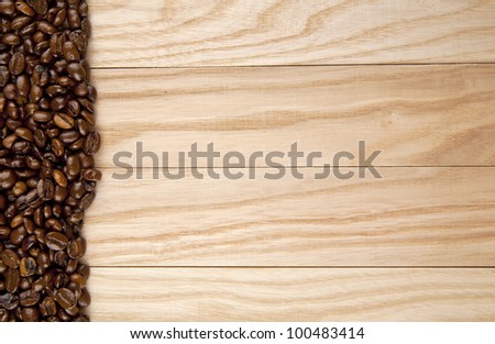 grains of coffee on a wooden background