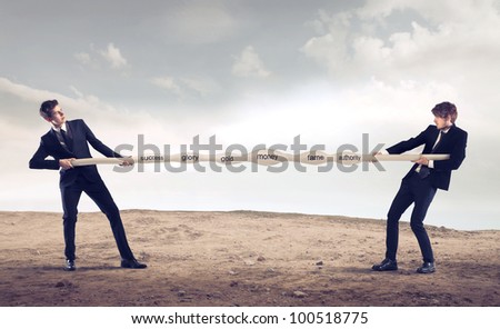 Two businessmen playing tog of war Royalty-Free Stock Photo #100518775
