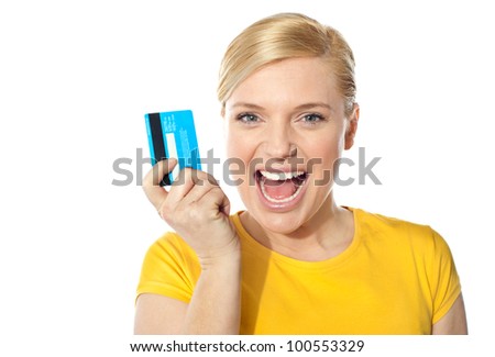 Blond sales girl posing with credit card and smiling at camera