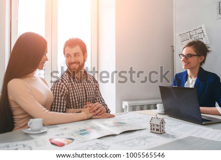 Young family couple purchase rent property real estate . Agent giving consultation to man and woman. Signing contract for buying house or flat or apartments