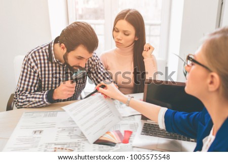 Young family couple purchase rent property real estate . Agent giving consultation to man and woman. Signing contract for buying house or flat. Sign a contract or agreement. Business Documentation