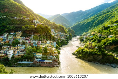 New edited version - Confluence of two rivers Alaknanda and Bhagirathi give rise to the holy river of Ganga / Ganges at one of the five Prayags called Dev Prayag. Uttarakhand river. Sunrise & greenery Royalty-Free Stock Photo #1005613207