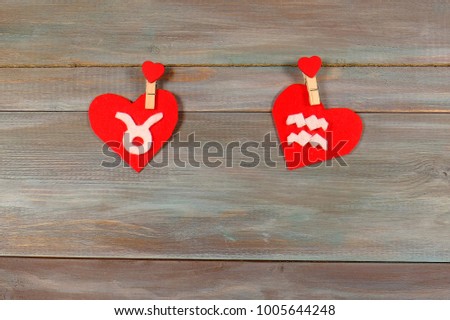 Taurus and Aquarius. signs of the zodiac and heart. wooden background. card. Love. unusual handwork