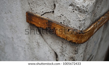 iron supports on old stone buildings