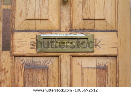 front view detail of residential wooden door with no junk mail inscription on it