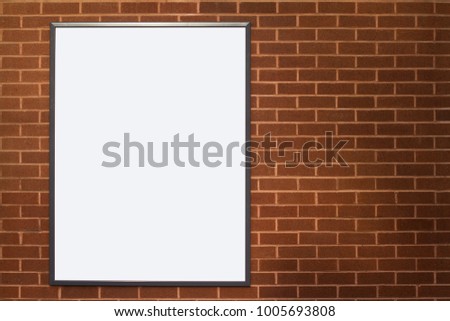 front view of blank white advertising outdoor poster billboard with copyspace on red brick wall