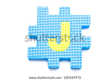 Rubber alphabet letter with drop shadow on white background, J