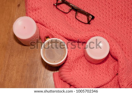 Tasty coffee or cocoa on a wooden background and pink tablecloth.