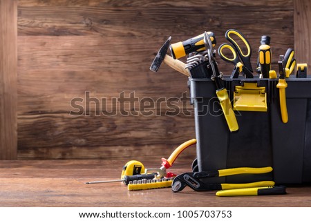 Plastic Black Container With Many Tools On Wooden Desk Royalty-Free Stock Photo #1005703753
