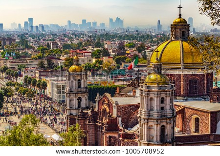 Mexico. Basilica of Our Lady of Guadalupe. Cupolas of the old basilica and cityscape of Mexico City on the far Royalty-Free Stock Photo #1005708952