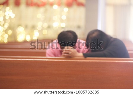 Women hold hands with men, pray for God in church.blurred photo