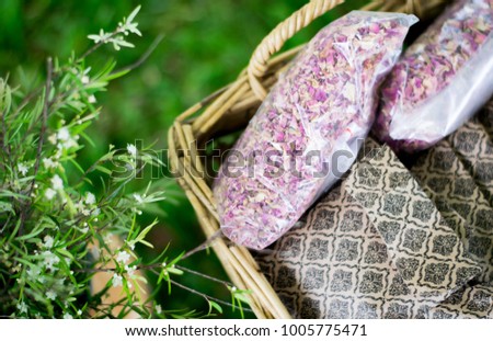 Rosemary, roses and natural packets in a basket