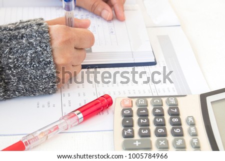 record expense income and financial statement yearly balance sheet with hand of woman working at office desk Royalty-Free Stock Photo #1005784966