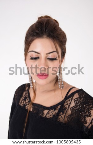Young pretty girl in black dress on white background