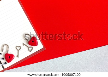 The top view shot of red heart padlock and key on notebook background for valentines day with copy space