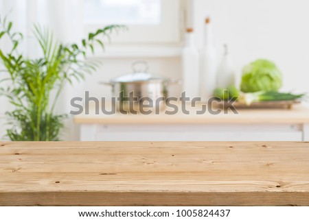 Table top with blurred kitchen interior as background Royalty-Free Stock Photo #1005824437