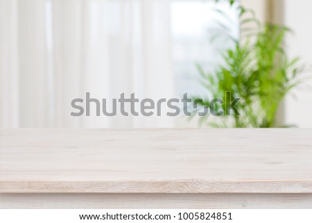Table mockup for display of product over blurred window background Royalty-Free Stock Photo #1005824851