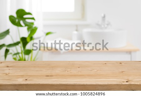 Empty tabletop for product display with blurred bathroom interior background Royalty-Free Stock Photo #1005824896