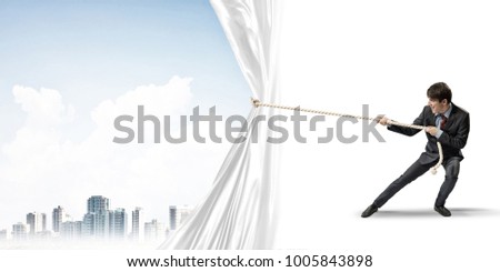 Businessman pulling white blank fabric. Place for text