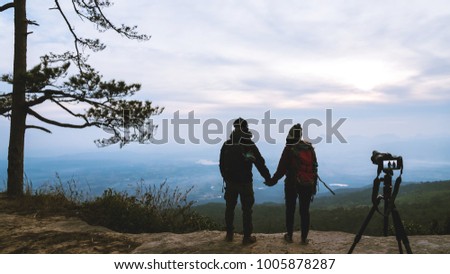 Photographer lover women and men asians travel relax in the holiday. Photograph mountain landscapes atmosphere in the morning. In the winter. In Thailand