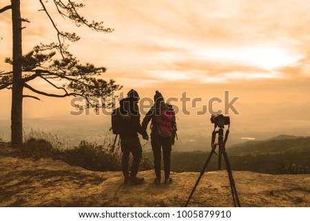 Photographer lover women and men asians travel relax in the holiday. Photograph mountain landscapes atmosphere in the morning. In the winter. In Thailand