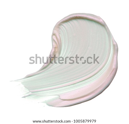 Stunning and exclusive smears and texture made with expensive face highlighter on white background. Strokes pearly cream or foundation for facial make-up, on a white background