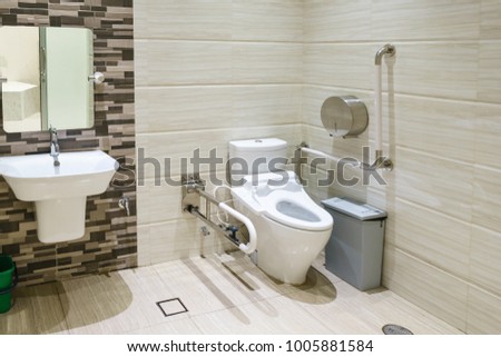 Interior of bathroom for the disabled or elderly people. Handrail for disabled and elderly people in the bathroom