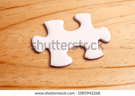 Missing jigsaw puzzle on wooden table. Copy Space
