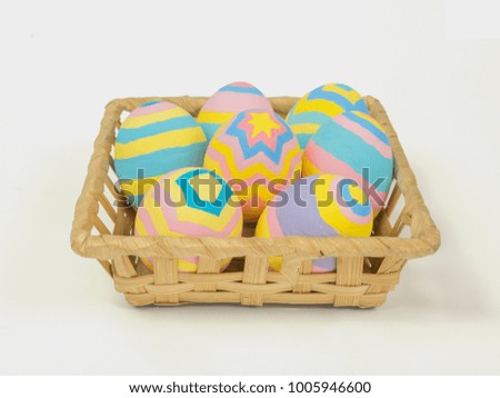 Painted easter eggs in a basket isolated on white background with clipping path, concept for Easter
