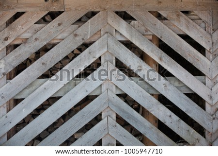 Art Wood planks wall of hangar of firewoods as background 