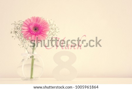 Image of International women day concept with beautiful flower in the vase on wooden table
