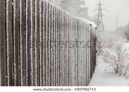 wooded fence with a foggy winter day