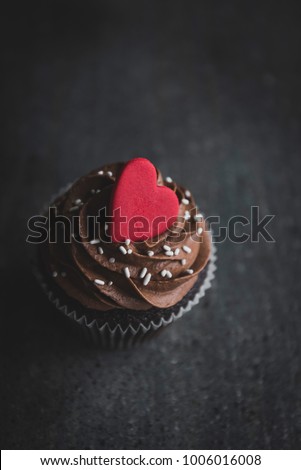 Romantic cup cake with chocolate cream served on the dark background,greating card,card,