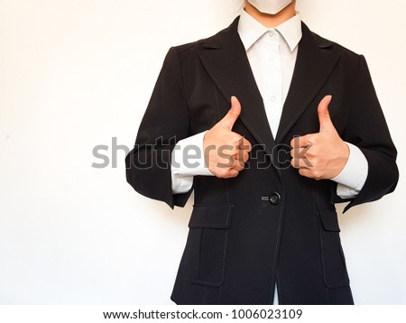 Business woman in black suit giving thumb up or great sign, like sign, Standing on white background, Business concept.