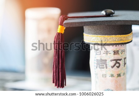 Concept of international graduate study abroad, graduation black cap on pile of foreign money Asian, JPY, EURO money. Education certificate of Abroad program. Vintage style.