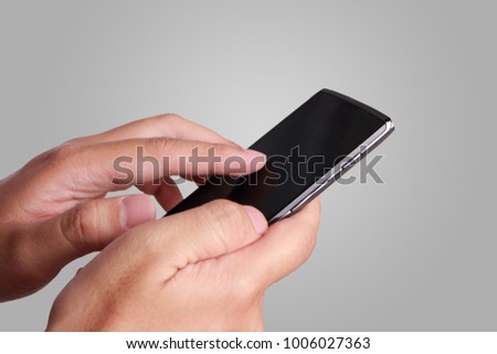 Close up image of hand holding and using smartphone, touching screen