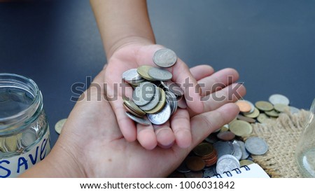 Coins on their hands, supported by a father's hands.Investment saving money  Interest Concept Education.