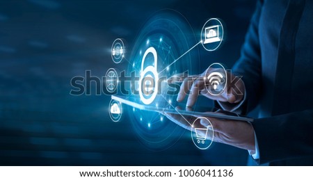 Businessman using tablet and set up network connection with shield guard to protected from cyber attacks. Network security system concept Royalty-Free Stock Photo #1006041136