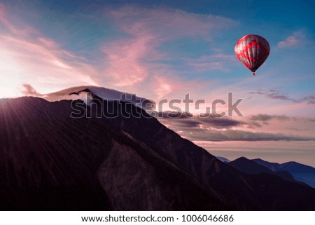 The dramatic and stunning sky and mountain and hot air balloon,red tone,winter,Taiwan. Royalty-Free Stock Photo #1006046686