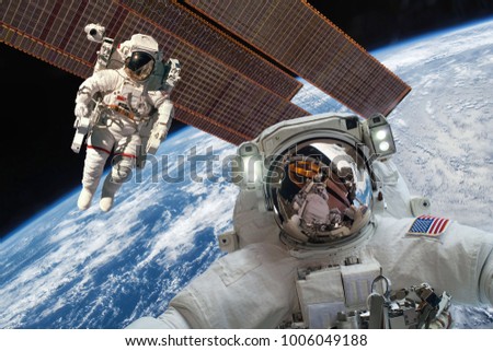 International Space Station and astronaut in outer space over the planet Earth. Elements of this image furnished by NASA.