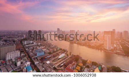 River curved over Bangkok city downtown skyline with after sunset sky background, Thailand