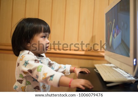 Children watching cartoons on the computer.
