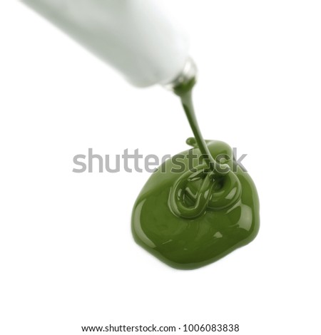 Paint spilling out of a dye tube isolated over the white background