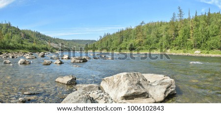 Panorama of a mountain river. A water summer landscape in the mountains of the Polar Urals.