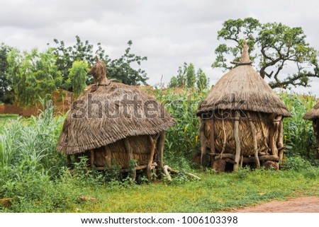 Two traditional african granaries made of wood and straw, Ouagadougou, Burkina Faso. Royalty-Free Stock Photo #1006103398
