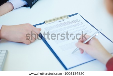 Business woman signing the contract document with pen on desk. Selective focus image on sign a contract.