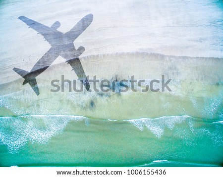 Aerial View of lonely beach with shadow of huge airplane