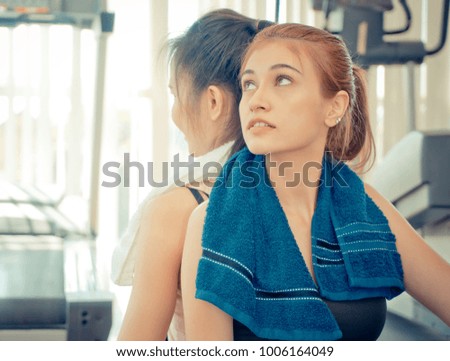 Fitness friend is sitting back to back in Fitness gym